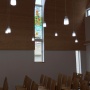 Interior view with the stained glass window. Photo: Daniel Nummela